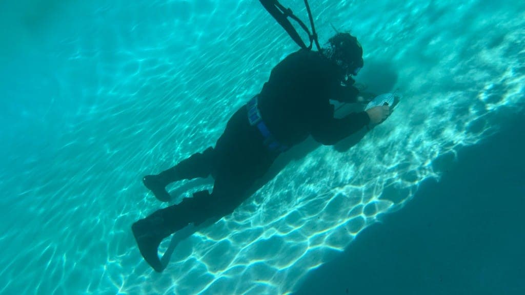 Underwater pool leak detection and repair on the pool floor