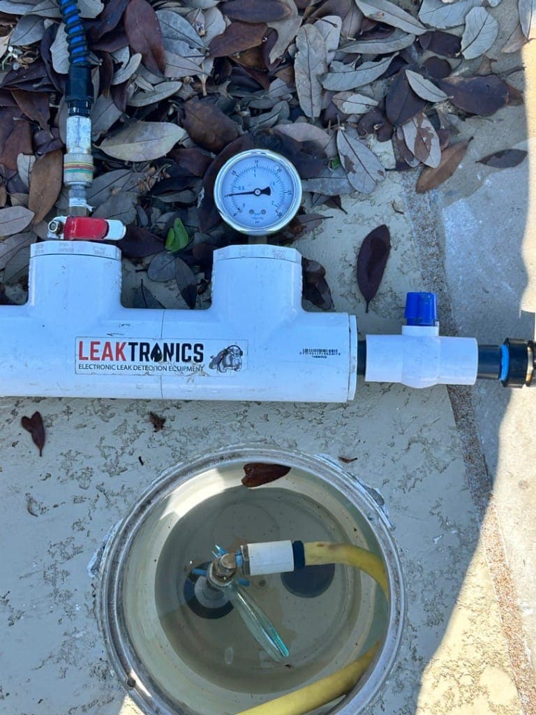 Leaktronics pressure testing rig connected to pool plumbing — Round Rock
