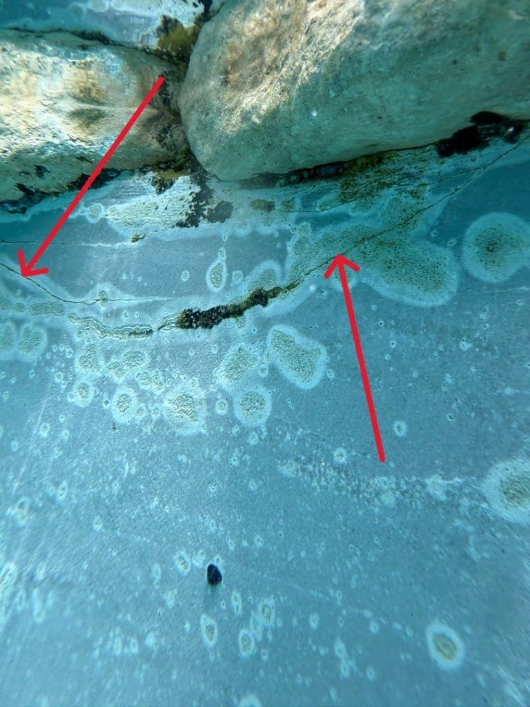Diver performing underwater pool leak inspection in Central Texas